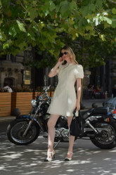 a lady in a short white Qipao dress